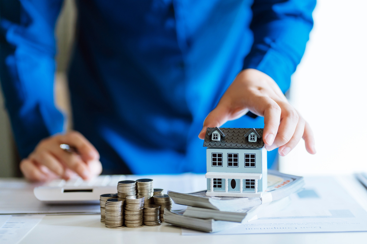 Saving Money for Real Estate Investment with with Stack of Money