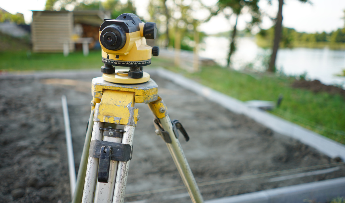 Surveyor equipment theodolite on the construction site. Land surveying with optical measurement tools. Theodolite on the site. Measurement on construction site.